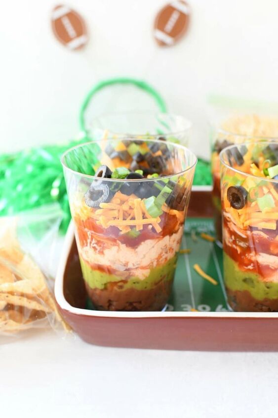7 layer game day individual dip cups, 7 layer Dip with Tortilla chips on a brown football tray