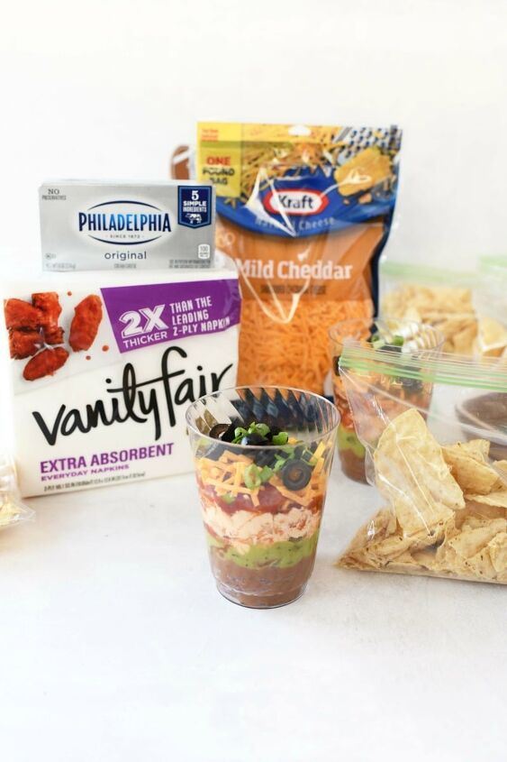 7 layer game day individual dip cups, 7 layer dip with ingredients from Walmart on a white table with groceries