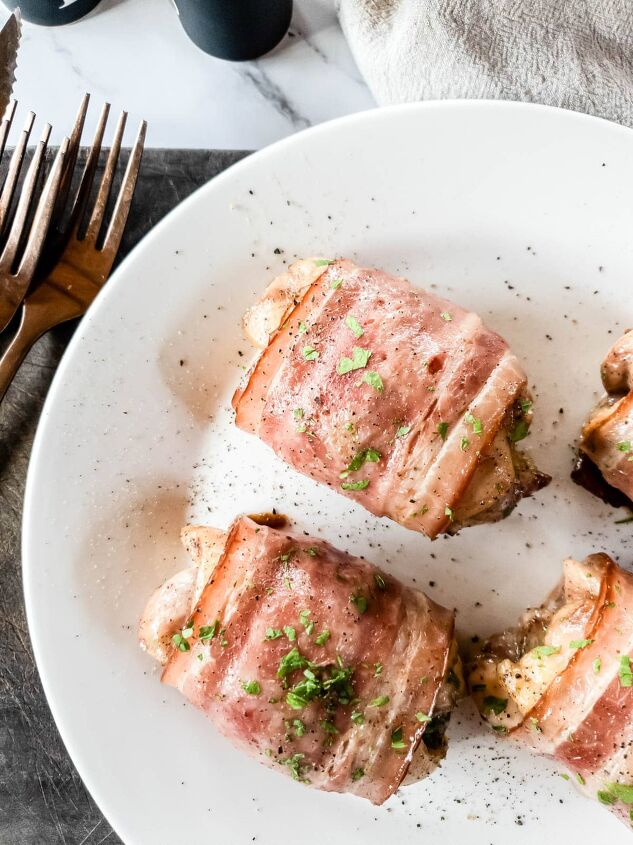 bacon wrapped chicken thighs in the oven so easy, Overhead view of baked chicken thighs with copper forks