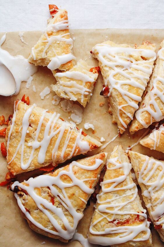honey scones, roasted kumquat scones on a baking sheet with a spoon of icing