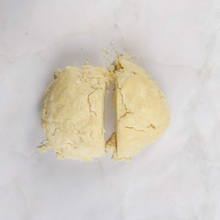 peach mango pie recipe, dough ball cut into two halves