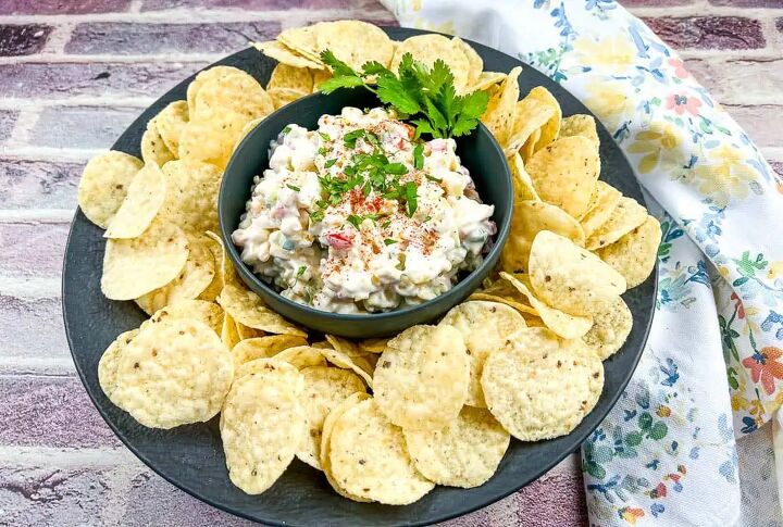 cold corn dip, Cold corn dip in a black bowl surrounded by tortilla chips
