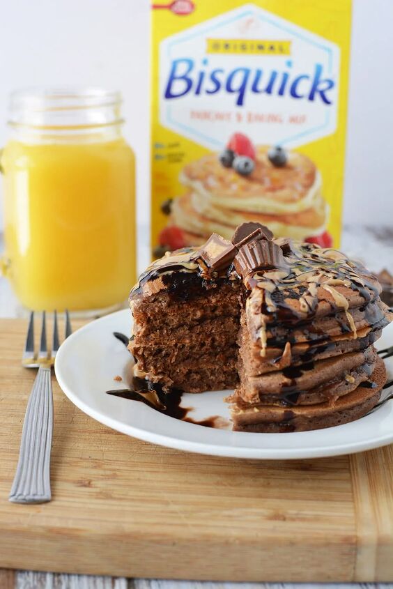 chocolate peanut butter pancakes, Chocolate PB pancakes on a plate in front of orange juice and a box of Bisquick