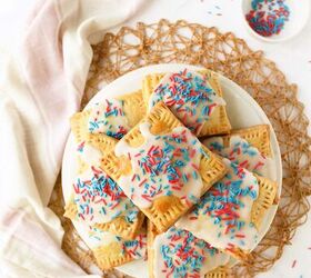 homemade berry pie tarts, A white plate of pie tarts with red and blue sprinkles