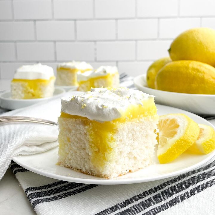 chocolate caramel poke cake, piece of lemon poke cake on white plate with bowl of lemons and plates of cake in background