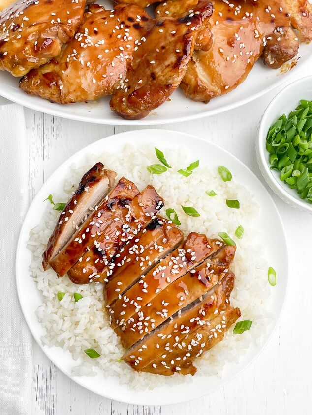 oven baked teriyaki chicken thighs boneless or bone in, sliced oven baked teriyaki chicken with green onions and sesame seeds on a bed of rice