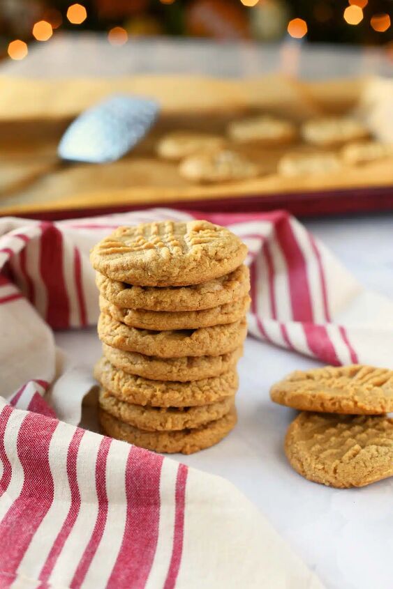 super easy 3 ingredient peanut butter cookies recipe, A stack of 3 ingredient peanut butter cookies near a red striped napkin