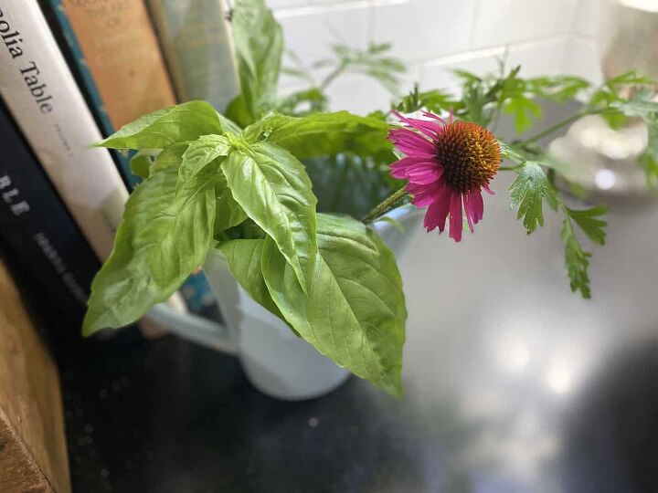 5 easy ways to use fresh basil from your garden, photo of basil and a few flowers in a vase on my kitchen cabinet