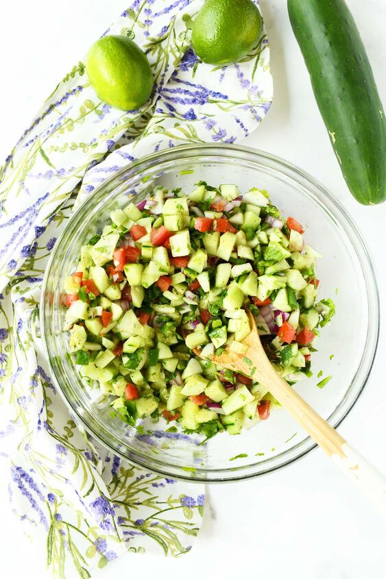 garden fresh cucumber salsa, A glass bowl with fresh cucumber salsa and a wooden spoon