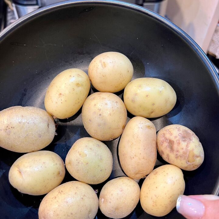 the crispiest air fryer smashed potatoes, A bowl holding mini golden potatoes