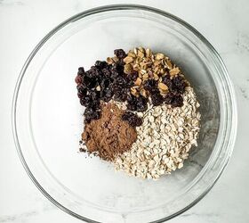 no bake chocolate granola bars vegan gluten free, cocoa powder in a glass mixing bowl with oats pistachios and dried cherries