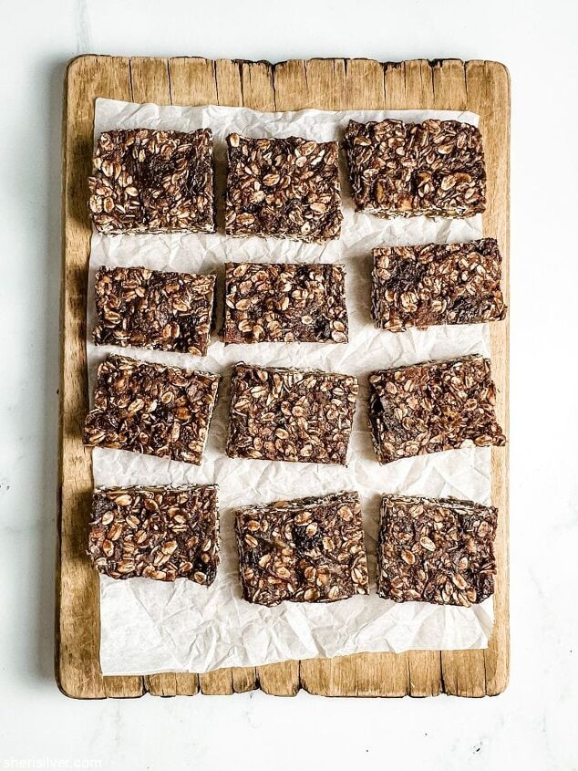 no bake chocolate granola bars vegan gluten free, chocolate granola bars on a parchment lined wooden board