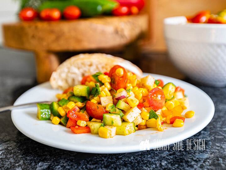 the best homemade pico recipe, Easy corn salad recipe on a white plate with a roll