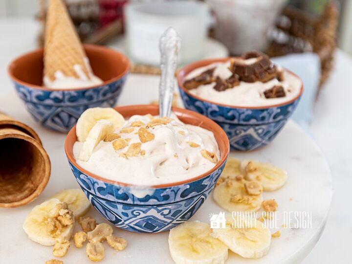 Peanut Butter Banana homemade ice cream topped with chopped nuts and sliced bananas in a blue and white bowl