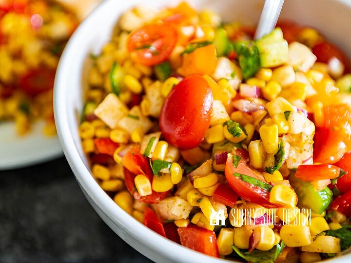 Corn jicama cucumber red onion cilantro and tomatoes in a bowl to make this easy corn salad recipe