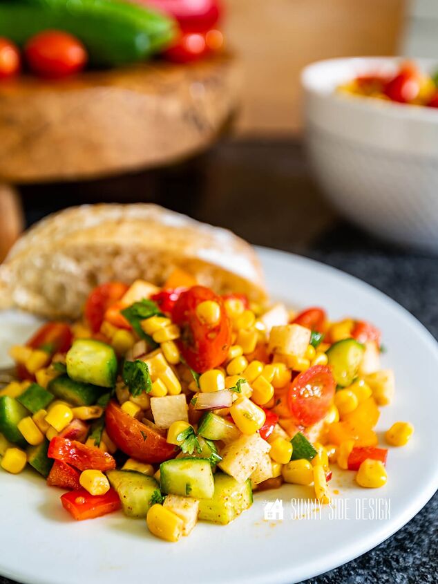 Easy corn salad recipe on a white plate with a roll