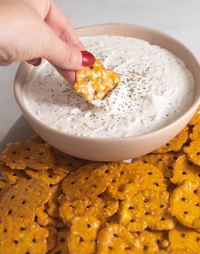 5 minute everything but the bagel dip dairy free, Everything but the bagel dip in a pink bowl with a pretzel thin dipping into the dip