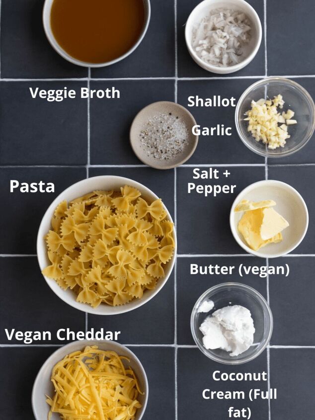 the creamiest vegan mac and cheese without cashews, All ingredients for mac and cheese on black tile in seperate bowls with labels