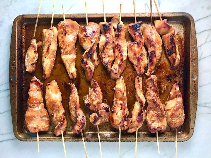 chinese chicken on a stick recipe garlic sesame sauce, Cooked chicken on skewers on a sheet pan for Chinese Chicken on a Stick Recipe