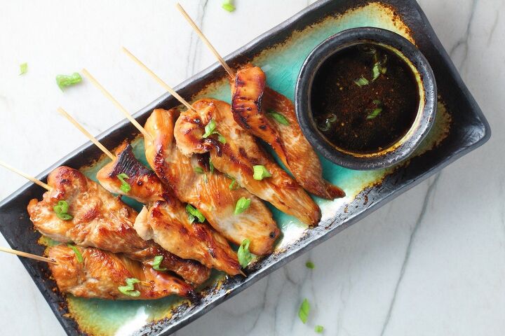 chinese chicken on a stick recipe garlic sesame sauce, Chinese Chicken on a Stick Recipe on a rectangle platter with small bowl of dipping sauce and pan in background