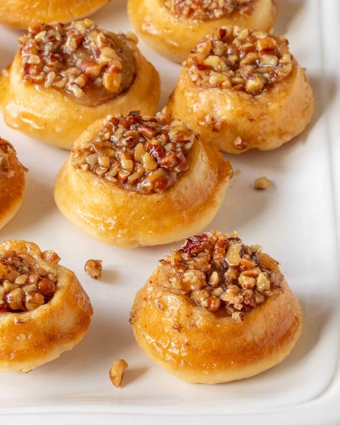 irresistibly delicious and easy to make a guide to creating mini peca, close up of a white platter holding mini pecan rolls