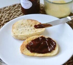 easy sourdough english muffins, sourdough English muffins cut open on with plate with jam and butter