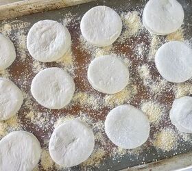 easy sourdough english muffins, sourdough English muffins rising on baking sheet with cornmeal