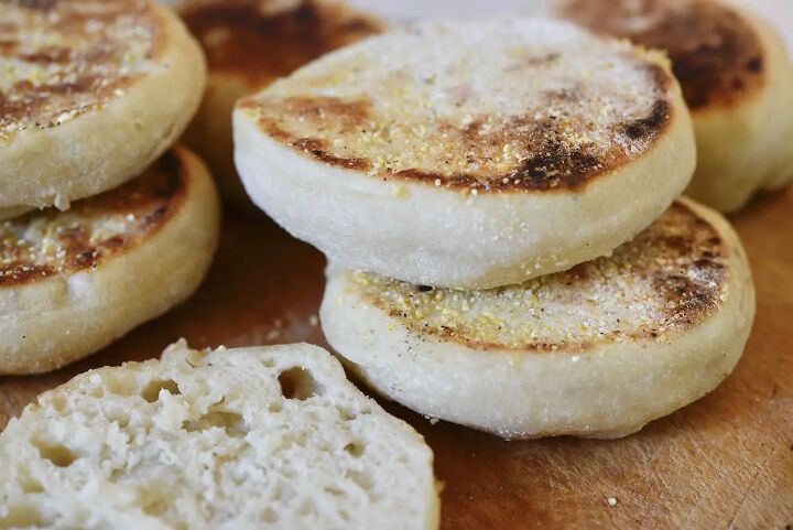 easy sourdough english muffins, sourdough English muffins stacked on wooden cutting board