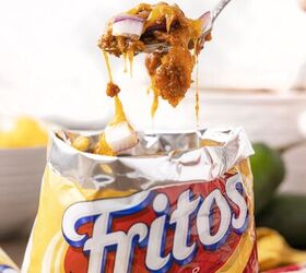 no plate needed when you make walking frito pie, scoop of frito pie being scooped out of fritos bag