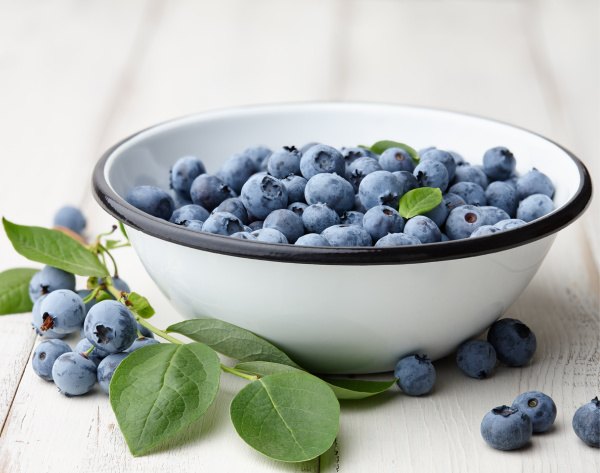 bonne maman blueberry swirl bundt cake, blueberries in a white enamel bowl