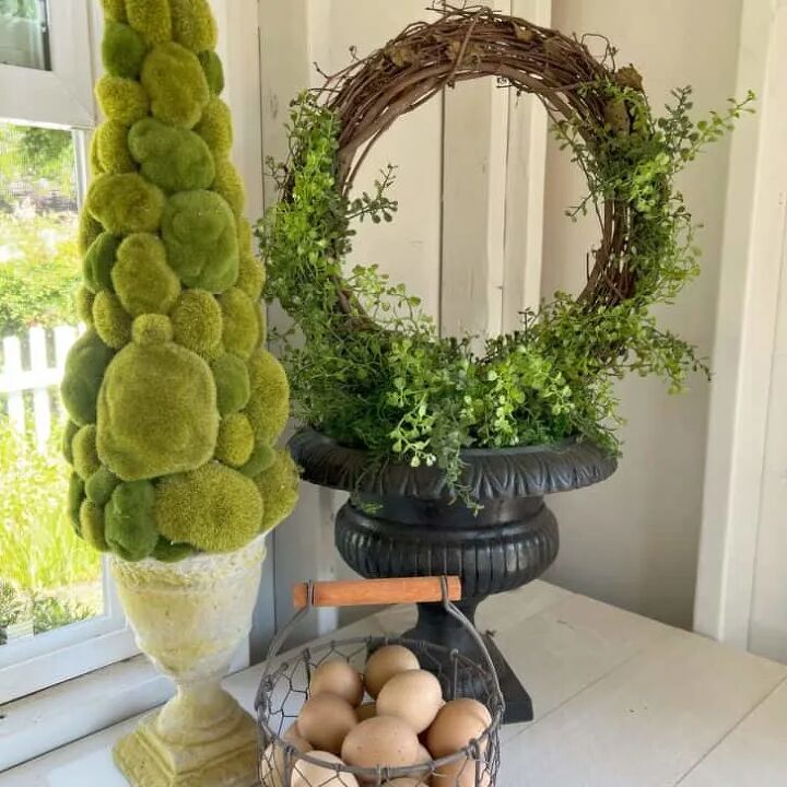 how to make delicious bedtime lavender chamomile vanilla milk, How to Make an Easy Topiary with a Vintage Urn grapevine wreath with boxwood greenery black iron urn wire basket with fresh brown eggs cone shaped green ball topiary in white concrete urn white wood slat counter