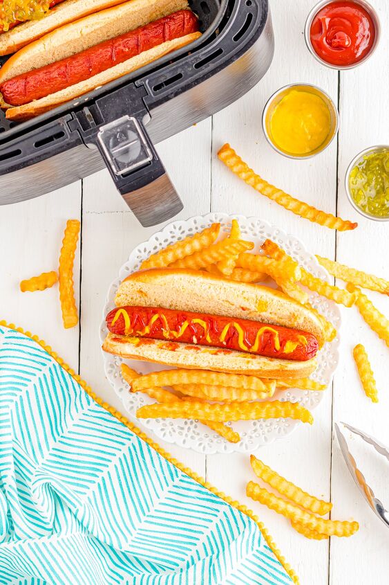 air fryer hot dogs, Air fryer hot dogs on table with fries and condiments