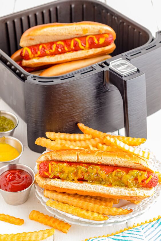 air fryer hot dogs, Hot dog on plate with fries Air fryer with more hot dogs in the background