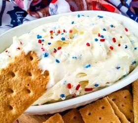 red white and blue cheesecake dip recipe, Dipping a graham cracker into red white and blue cheesecake dip