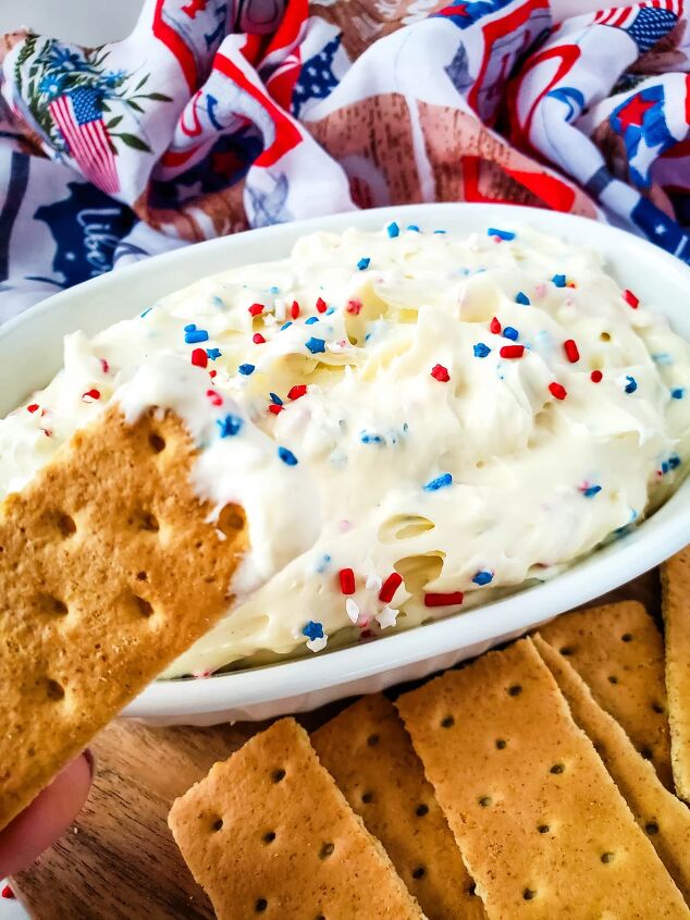 red white and blue cheesecake dip recipe, Dipping a graham cracker into red white and blue cheesecake dip