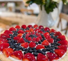 how to make a fresh and fulfilling fruit pizza with lemon glaze, fruit pizza with lemon glaze features a sugar cookie crust cream cheese icing then topped with strawberries and blueberries