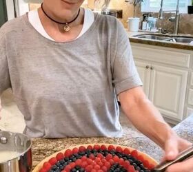how to make a fresh and fulfilling fruit pizza with lemon glaze, fruit pizza topped with lemon glaze features a sugar cookie crust cream cheese icing then topped with strawberries and blueberries