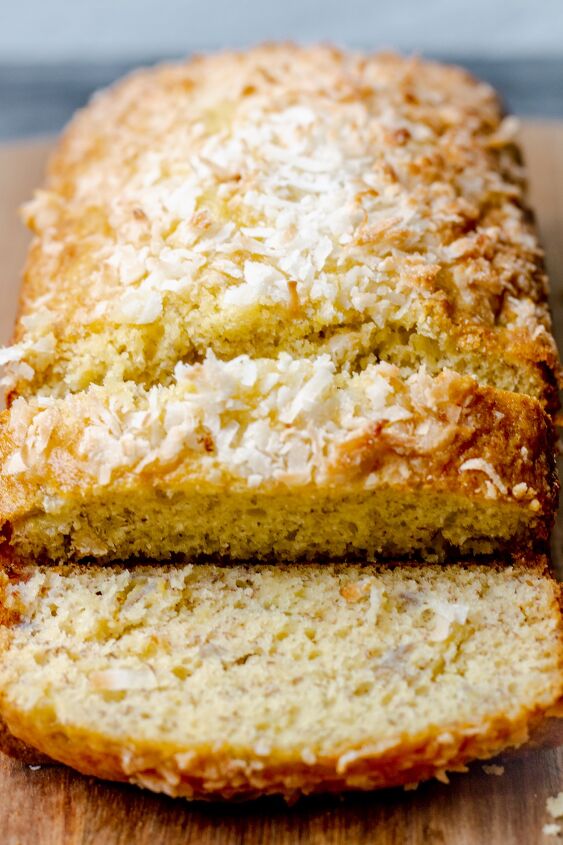 the best snickerdoodle zucchini bread recipe, overhead view of a sliced loaf of cake mix banana bread with coconut sprinkled on top