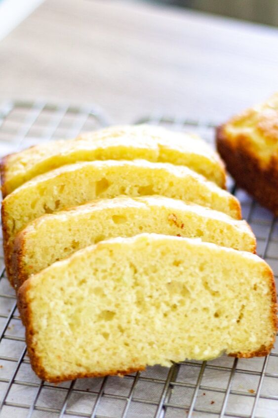 the best snickerdoodle zucchini bread recipe, sliced easy lemon zucchini bread on a wire cooling rack