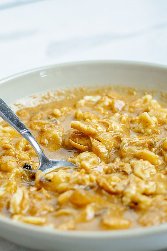 how to make the most amazing chicken paprikash soup in 30 minutes, close up of a bowl with a spoon full of chicken and spaetzels