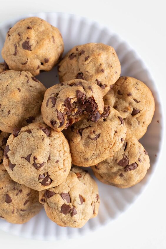 this 4 ingredient chocolate chip peanut butter cookie will be your fav, chunky chocolate chip cookies served on a small white plate