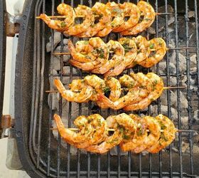 greek grilled shrimp with basil orange orzo, Marinated shrimp skewers on a BBQ grill