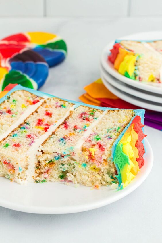 how to make a funfetti rainbow cake perfect for every celebration, pretty rainbow cake spice on a small white plate