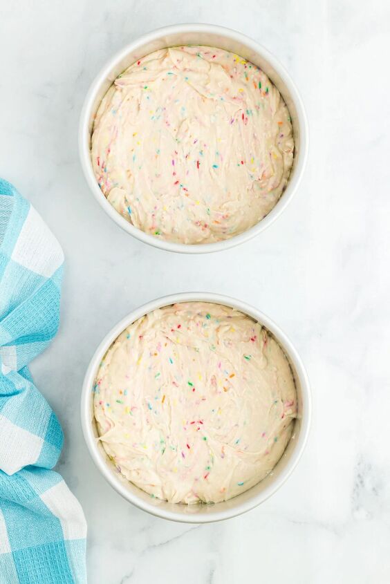 how to make a funfetti rainbow cake perfect for every celebration, cake batter added to cake pans