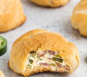 jalapeno popper rolls using crescent rolls, jalapeno popper with bite taken to reveal the cream cheese filling inside