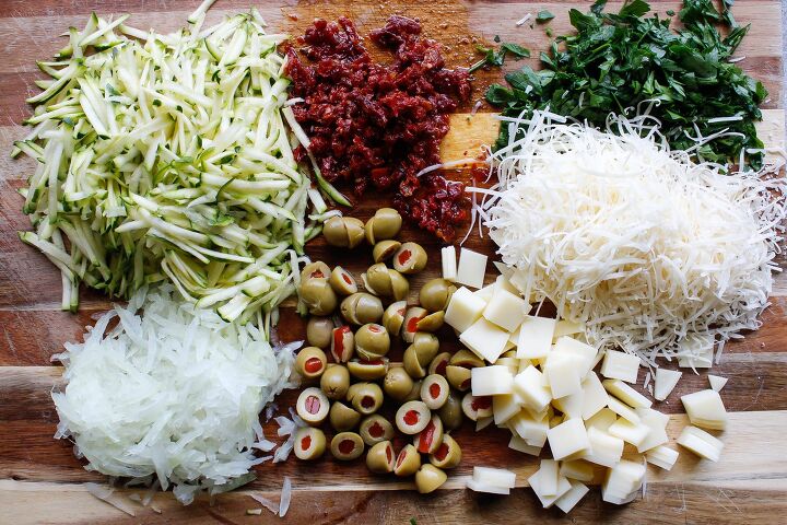 pasta salad with sun dried tomatoes green olives provolone, ingredients for pasta salad with green olives on a cutting board