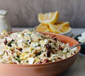 pasta salad with sun dried tomatoes green olives provolone, lemon orzo pasta salad in a red bowl
