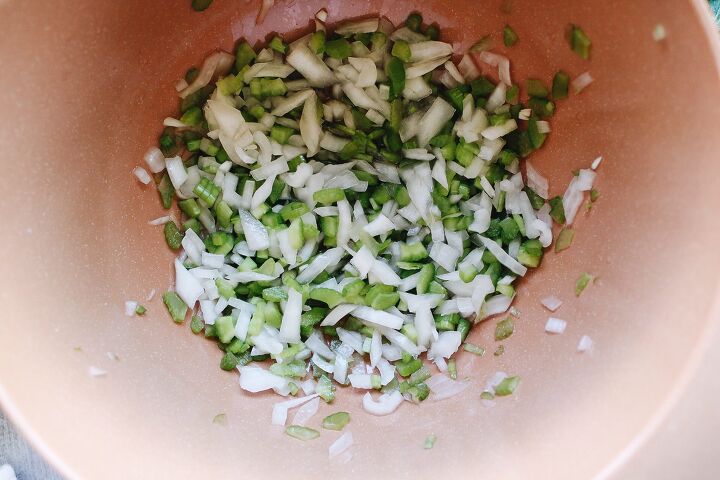 curry chicken salad with grapes, diced onion and celery in a bowl with vinegar salt and sugar