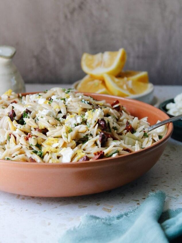 curry chicken salad with grapes, lemon orzo pasta salad in a red bowl