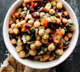 curry chicken salad with grapes, chickpea and black bean salad in a bowl on a dark background